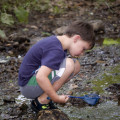 child_fishing_near_stream